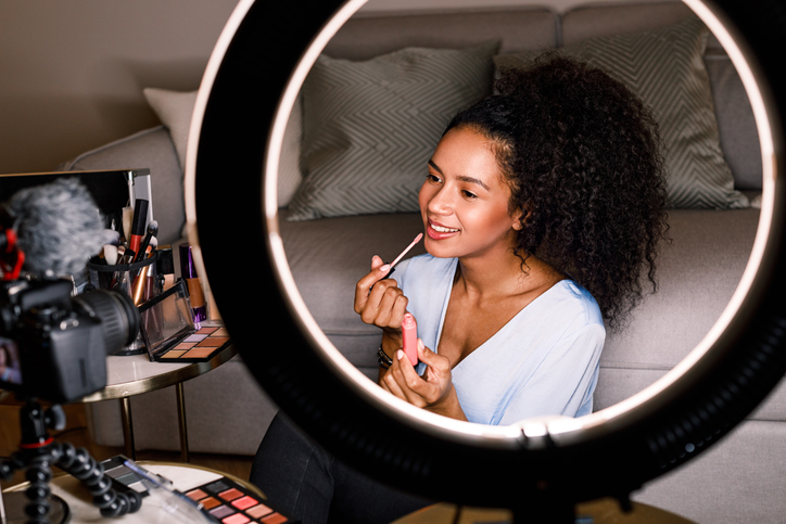 Influencer showcasing cosmetology skills while filming a social media video